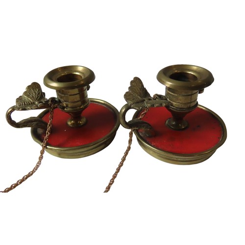 579 - A PAIR OF FRENCH 18TH CENTURY ORMULU DWARF CHAMBERSTICKS, turned tapering sconces on a vermillion la... 