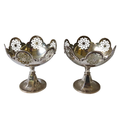 648 - A PAIR OF MAPPIN & WEBB VINTAGE SILVER SWEETMEAT DISHES, undulating scroll edge rims with pierce... 