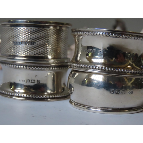 624 - FOUR SILVER NAPKIN RINGS, DECANTER LABEL AND BOTTLE RING, together with twelve plated napkin rings, ... 