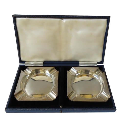 631 - A PAIR OF SILVER ASHTRAYS IN PRESENTATION CASE, the square form trays with engine turned decoration,... 