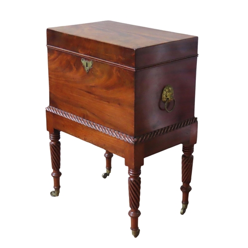 67 - A GEORGE IV MAHOGANY CELLARETTE ON STAND, CIRCA 1825, rectangular form flanked by twin lion's head r... 