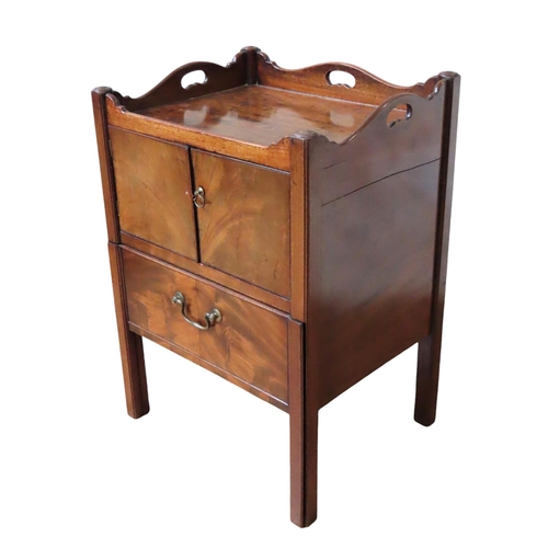 52 - A  GEORGE III MAHOGANY COMMODE, three quarter galleried top over twin cupboard doors, with pull out ... 