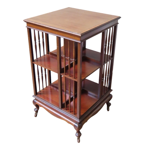 59 - AN EDWARDIAN MAHOGANY CROSS BANDED REVOLVING BOOKCASE, of typical square form, the two-tier bookcase... 