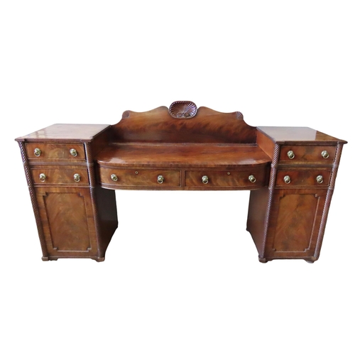 22 - A GEORGE IV MAHOGANY SIDEBOARD, constructed in three sections, comprised of a pair of rope twist pil... 