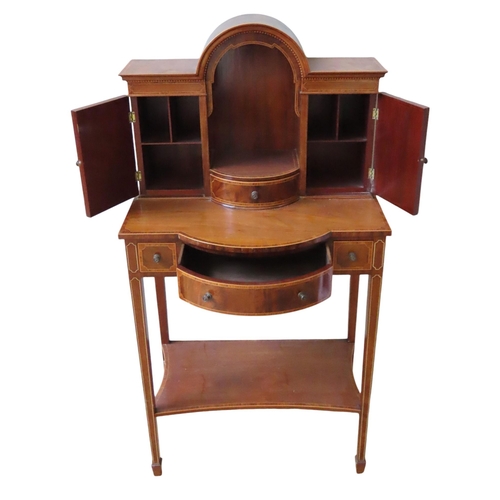 24 - AN EDWARDIAN MAHOGANY AND CROSS BANDED BONHEUR DU JOUR, the break arch central recess over a bow fro... 