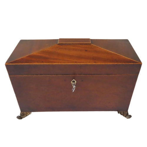 212 - A REGENCY MAHOGANY TEA CADDY, CIRCA 1810, rectangular sarcophagus form with twin lion's head ring ha... 