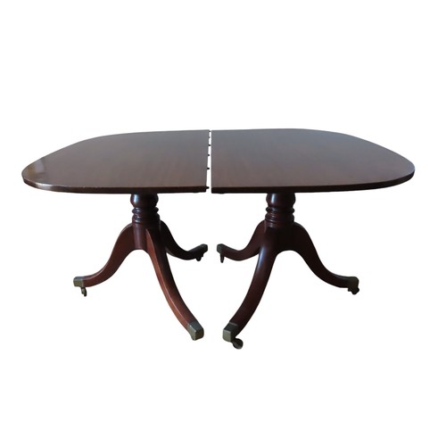 94 - A GEORGE III MAHOGANY TWIN PEDESTAL DINING TABLE, with extra leaf insertion, the rectangular top rai... 