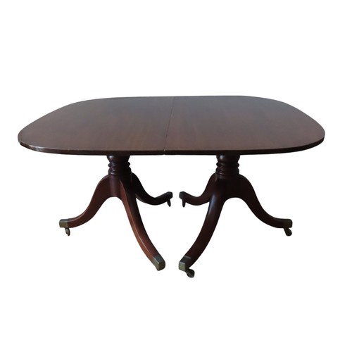 94 - A GEORGE III MAHOGANY TWIN PEDESTAL DINING TABLE, with extra leaf insertion, the rectangular top rai... 