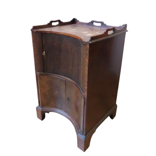 100 - A GEORGE III MAHOGANY INVERTED BOW FRONT COMMODE, three quarter galleried top over a tambour roll do... 