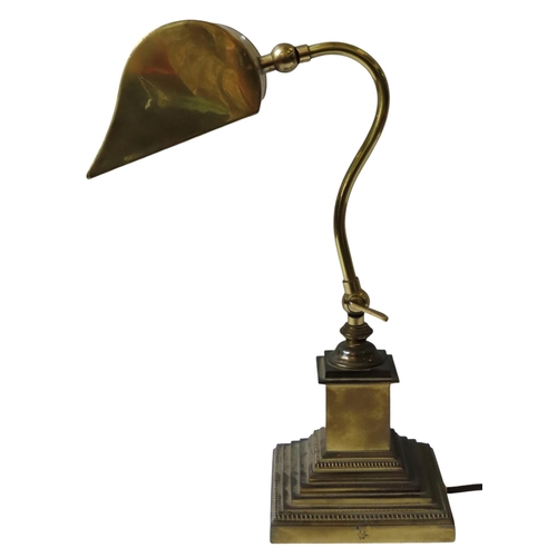 195 - A VINTAGE BRASS 'BANKER'S' LAMP, adjustable angle poise stem and curved shade, raised on a graduated... 