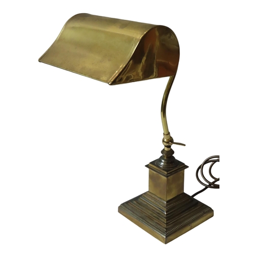 195 - A VINTAGE BRASS 'BANKER'S' LAMP, adjustable angle poise stem and curved shade, raised on a graduated... 