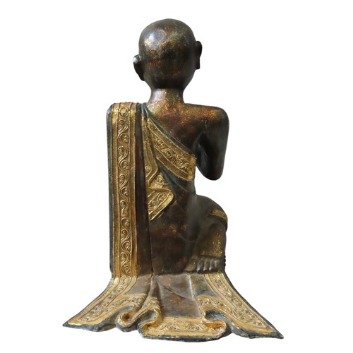 222 - BURMESE GILDED WOODEN KNEELING FIGURE of a praying monk draped in a gilded sash with tube lined deco... 