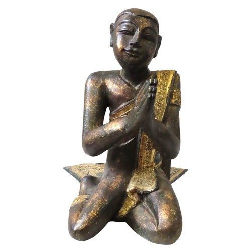 222 - BURMESE GILDED WOODEN KNEELING FIGURE of a praying monk draped in a gilded sash with tube lined deco... 