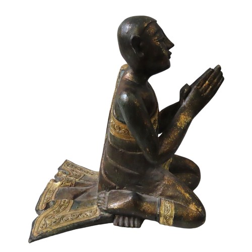 222 - BURMESE GILDED WOODEN KNEELING FIGURE of a praying monk draped in a gilded sash with tube lined deco... 