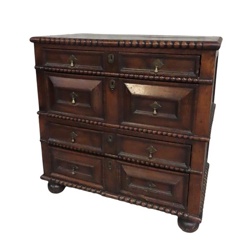 49 - AN OAK PANELLED ATTIC CHEST OF DRAWERS, rectangular top with bobbin turned edge over four alternatin... 