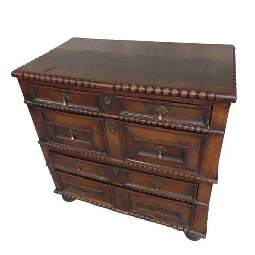 49 - AN OAK PANELLED ATTIC CHEST OF DRAWERS, rectangular top with bobbin turned edge over four alternatin... 