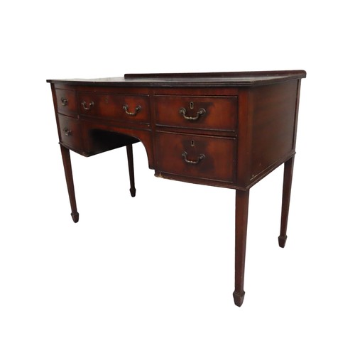 37 - A LATE 19TH CENTURY MAHOGANY WRITING DESK, bow front form, with a long frieze drawer flanked by four... 