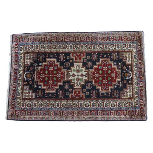 152 - MACHINE WOVEN RUG with deep layered border and three large medallions on navy blue ground central pa... 