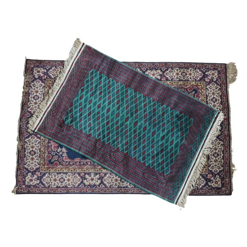 149 - EASTERN BORDERED WOOL RUG AND SMALLER GREEN INDIAN WOOL RUGEastern bordered wool rug on navy blue gr... 