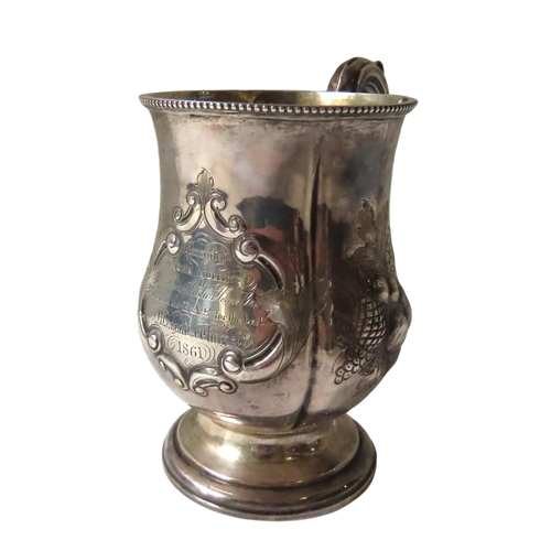 686 - A VICTORIAN SILVER PRESENTATION MUG, lobed melon form with elegant scroll handle, beaded edge rim an... 