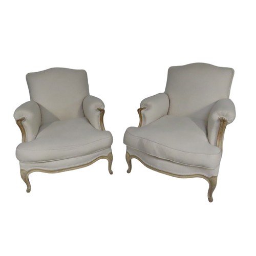 93 - A PAIR OF CREAM UPHOLSTERED LOUIS XV STYLE SALON ARMCHAIRS,  the beechwood washed frames with uphols... 