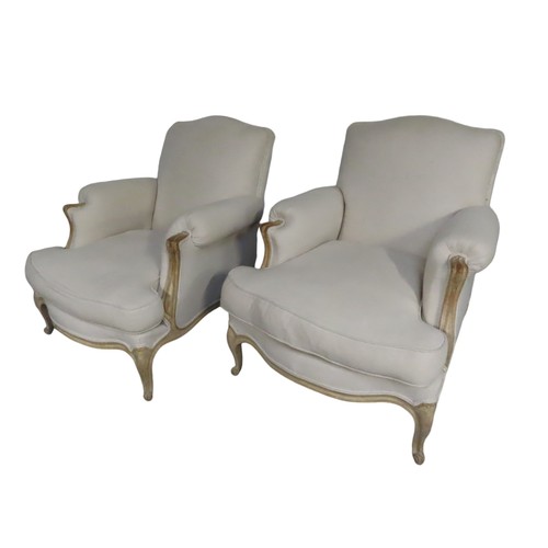 93 - A PAIR OF CREAM UPHOLSTERED LOUIS XV STYLE SALON ARMCHAIRS,  the beechwood washed frames with uphols... 