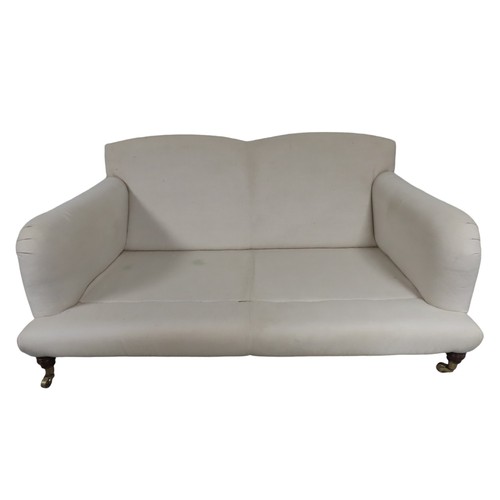 81 - A CONTEMPORARY TWO SEAT HOWARD-STYLE SETTEE, the calico covered frame with twin arch back panel the ... 