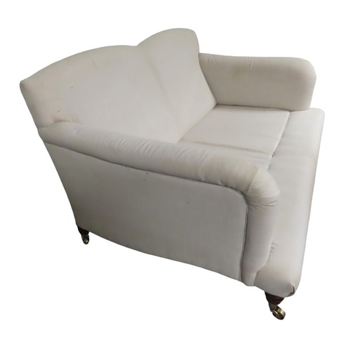 81 - A CONTEMPORARY TWO SEAT HOWARD-STYLE SETTEE, the calico covered frame with twin arch back panel the ... 