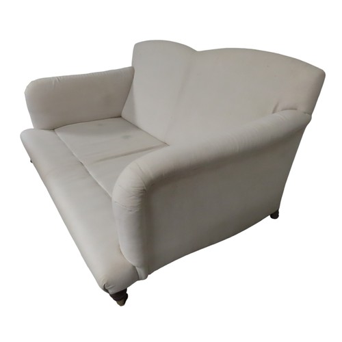 81 - A CONTEMPORARY TWO SEAT HOWARD-STYLE SETTEE, the calico covered frame with twin arch back panel the ... 