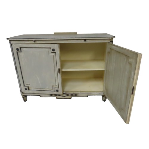 34 - A FRENCH TWO DOOR SIDE CUPBOARD, rectangular top with canted corners over a brushing slide, the twin... 