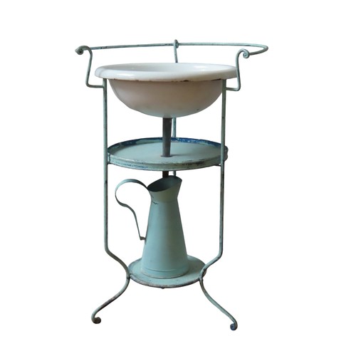 71 - A CIRCULAR WROUGHT IRON WASHSTAND with enamel basin and two shelves. Raised on a triform base, with ... 