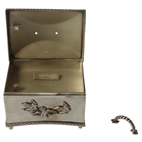 627 - A SILVER CASED CHRISTENING MUSIC BOX, by the St James House Company, rectangular form with applied p... 