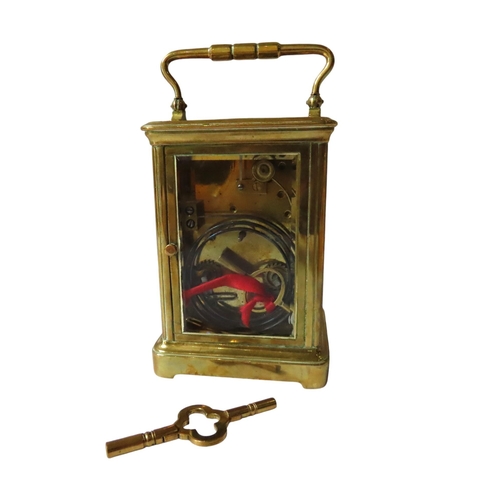 186 - A STRIKING CARRIAGE CLOCK, white enamel dial, replaced lever platform, in a comiche case winding key... 