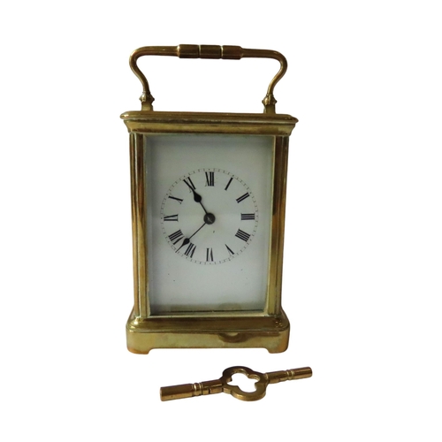 186 - A STRIKING CARRIAGE CLOCK, white enamel dial, replaced lever platform, in a comiche case winding key... 