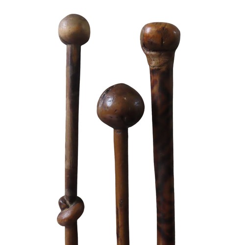 275 - THREE WOODEN POMMEL HANDED WALKING STICKS one with tiger skin effect, one with rope knot detail and ... 