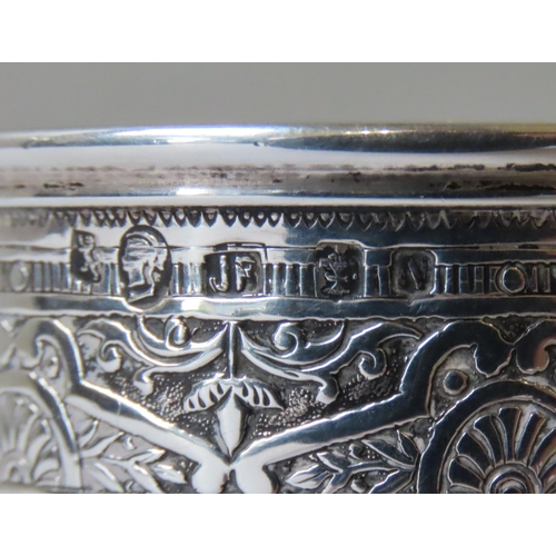 666 - AN ORNATE VICTORIAN SCOTTISH SILVER CHRISTENING MUG, the repousse decorated sides adorned with seven... 