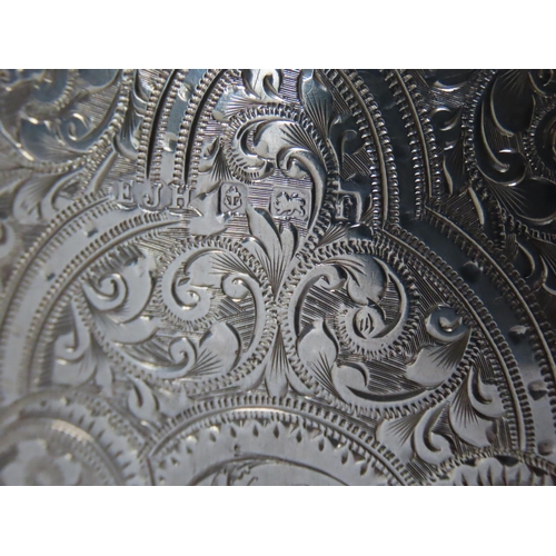 644 - AN ORNATE EDWARDIAN SILVER AIDE MEMOIRE, the monogrammed case covered in highly ornate chased scroll... 