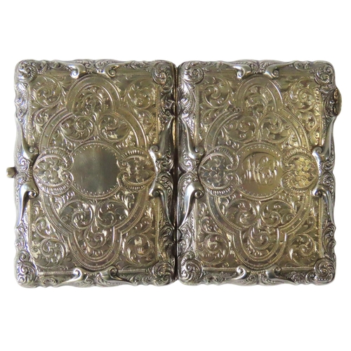 644 - AN ORNATE EDWARDIAN SILVER AIDE MEMOIRE, the monogrammed case covered in highly ornate chased scroll... 