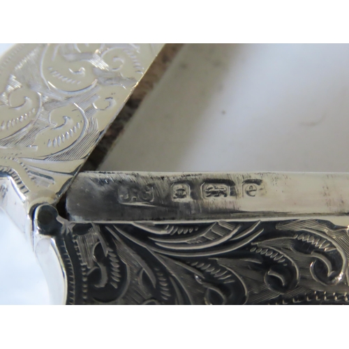 637 - AN EDWARDIAN SILVER CARD CASE, rectangular cartouche form with ornate chased scroll foliate decorati... 