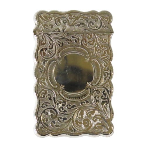 637 - AN EDWARDIAN SILVER CARD CASE, rectangular cartouche form with ornate chased scroll foliate decorati... 