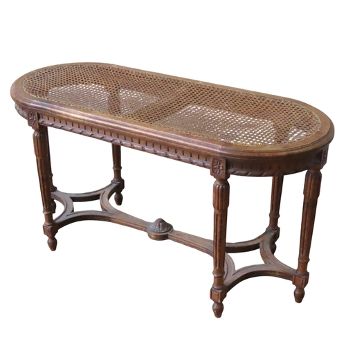 42 - A LOUIS XVI STYLE CANE TOP PIANO STOOL, LATE 19TH CENTURY, the curved end rectangular top raised on ... 