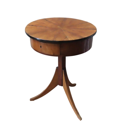 18 - A FRENCH FRUITWOOD SEWING TABLE, the drum form top with a compartmented frieze drawer, raised on a h... 