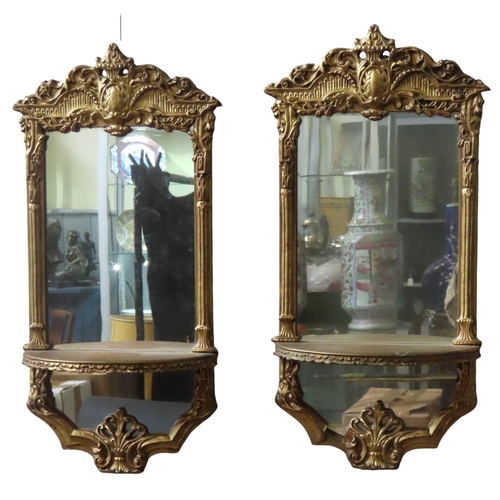 201 - A PAIR OF VINTAGE MIRRORED WALL SHELVES, in the Regency style, the gilt gesso frames with scrolling ... 