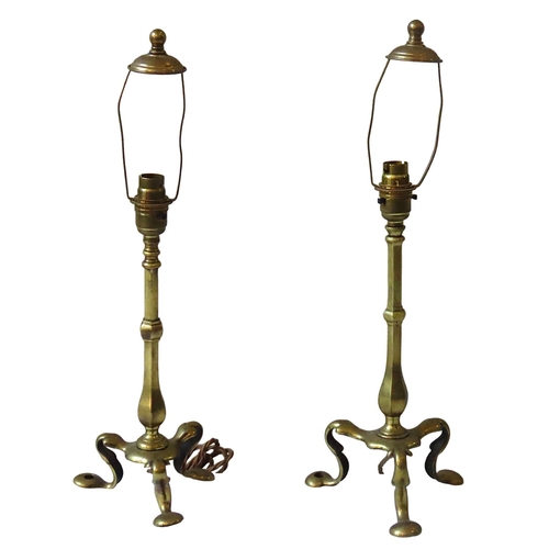 196 - TWO VINTAGE BRASS PULLMAN LAMPS, with hexagonal faceted baluster pillars on stylised triform scrolli... 