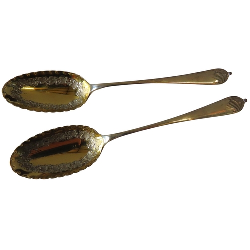 670 - A PAIR OF ELKINGTON SILVER PARCEL GILT SERVING SPOONS, the crimped edge gilded bowls with chased vin... 