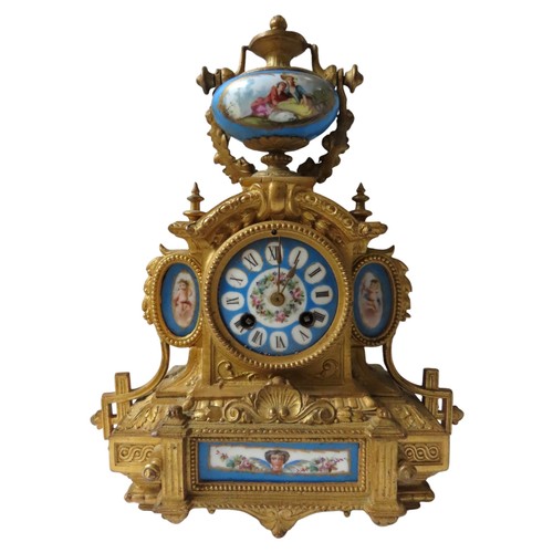 185 - A FRENCH GILT MANTEL CLOCK WITH SEVRES STYLE PORCELAIN MOUNTS surmounted by a vase shaped urn with s... 