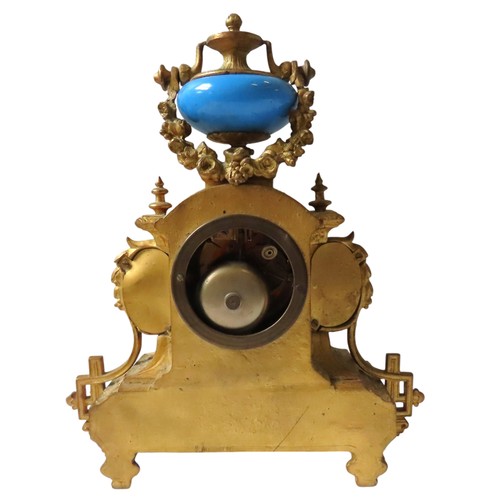 185 - A FRENCH GILT MANTEL CLOCK WITH SEVRES STYLE PORCELAIN MOUNTS surmounted by a vase shaped urn with s... 