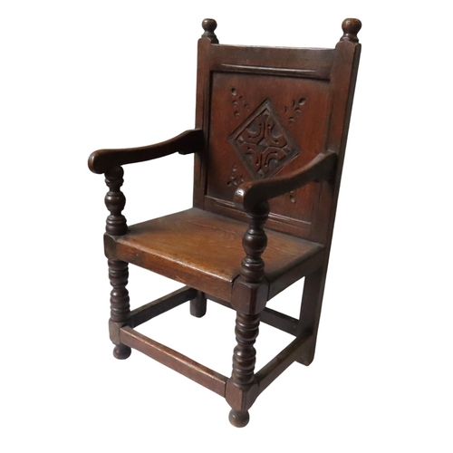 8 - A 19TH CENTURY CHILD'S OAK WAINSCOT CHAIR, in the Charles II style, with carved back panel, scroll a... 