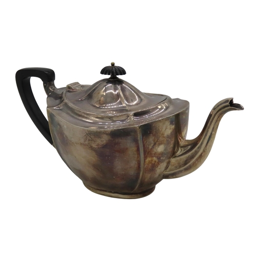 698 - A VINTAGE SILVER TEAPOT, fluted tapering oval form with ebonised handle and scrolling fluted spout, ... 