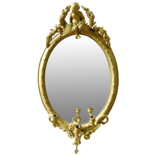 208 - A REGENCY STYLE OVAL WALL MIRROR, the oval plate in a beaded edge gilt gesso frame, surmounted by a ... 